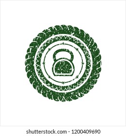 Green kettlebell icon inside rubber grunge texture stamp