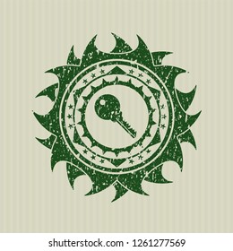 Green key icon inside distress rubber seal with grunge texture