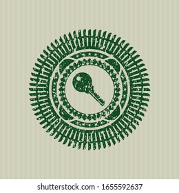 Symbol mit grünem Schlüssel in Stempel mit Notrufgrunge-Stil