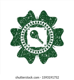 Green key icon inside grunge style stamp