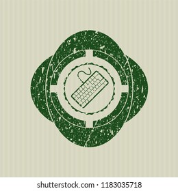 Green keyboard icon inside distressed with rubber seal texture