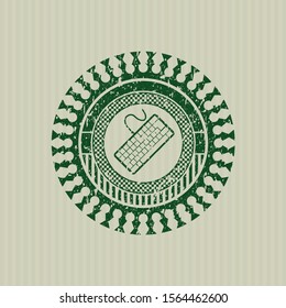 Green keyboard icon inside distressed grunge stamp