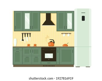 
Green kitchen with built-in cooker hood and oven and two-compartment refrigerator. A boiling orange teapot sits on the stove; teacups and a sugar bowl of the same color are on the countertop.