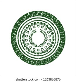 Green laurel wreath icon inside distressed rubber stamp