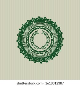 Green laurel wreath icon inside distressed rubber stamp with grunge texture