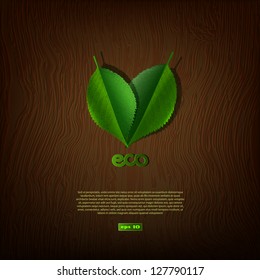 Green leaves on a background of wood texture, ecological concept