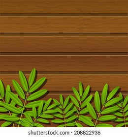 Green leaves on wooden background