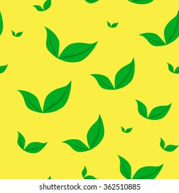 Green leaves on a yellow background. Vector pattern.