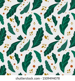 Green leaves seamless background with yellow and orange shapes pattern