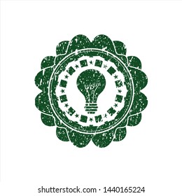Green light bulb icon inside rubber seal with grunge texture