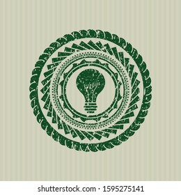 Green light bulb icon inside distressed rubber seal