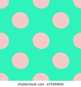 Green and light pink hand drawn polka dots seamless vector pattern. Decorative repeated background for print, textile, t-shirt, fabric, wallpaper, poster, home decor, packaging, or web use.