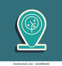 Green Location and tree icon isolated on blue background. Long shadow style. Vector Illustration