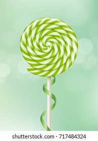 Green lollipop on green background.
