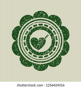 Green love icon inside distress rubber seal
