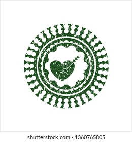 Green love icon inside distressed rubber seal