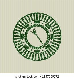 Green magic stick icon inside distress rubber seal with grunge texture