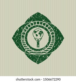 Green man lifting world icon inside distressed rubber stamp