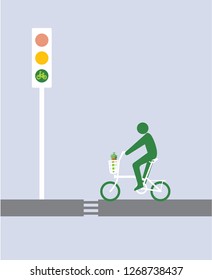 A green man riding a bicycle made a stop on the rode before the traffic light. 