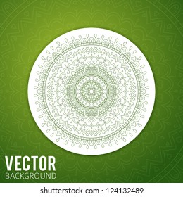 Green mandala ornament on green background.