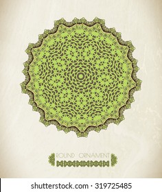 Green  mandala . Round ornament pattern isolated on paper texture