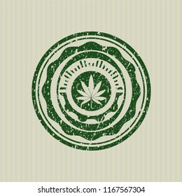 Green marijuana leaf icon inside distressed rubber stamp