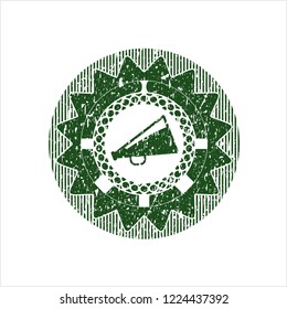 Green megaphone icon inside rubber grunge texture seal