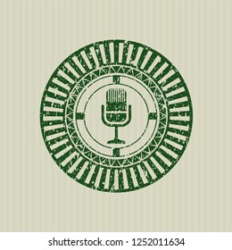 Green microphone icon inside grunge seal