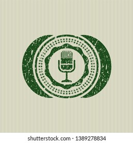 Green microphone icon inside rubber grunge seal