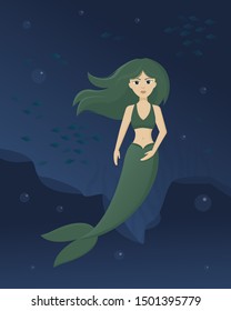 Green mile mermaid swims on the ocean floor with fishes.