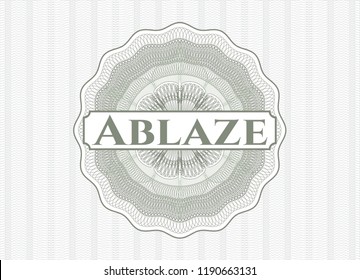 Green money style emblem or rosette with text Ablaze inside