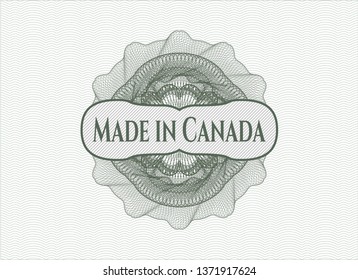 Green money style emblem or rosette with text Made in Canada inside