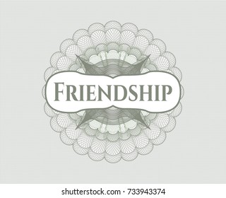Green money style emblem or rosette with text Friendship inside