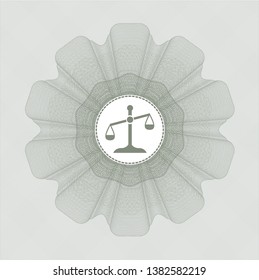 Green money style rosette with scale icon inside