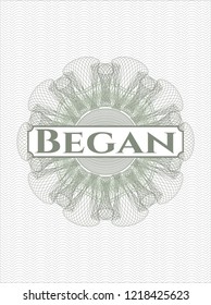 Green money style rosette with text Began inside