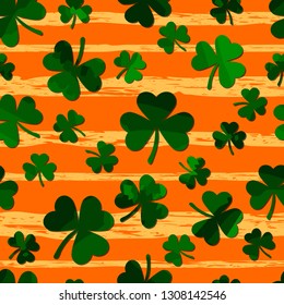 green motley shamrock on grunge gold stripes. vector seamless pattern. patrick repetitive background. St. Patrick's Day. textile paint. fabric swatch. wrapping paper. modern stylish texture