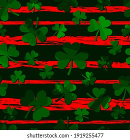 green motley shamrock shapes on red grungy stripes. vector seamless pattern. saint patrick's day. fabric swatch. wrapping paper. continuous print. design element for textile, banner, apparel, decor