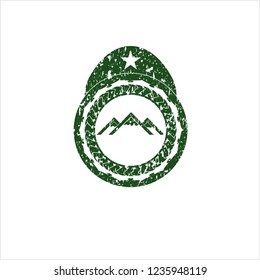 Green mountain icon inside distress rubber grunge seal
