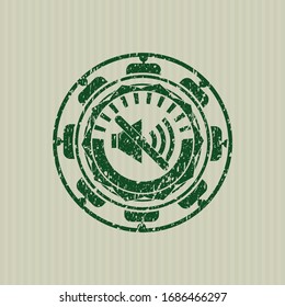 Green mute icon inside distressed rubber seal with grunge texture