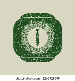 Green necktie icon inside distressed rubber grunge stamp
