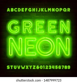 Green neon alphabet font. Bright neon letters and numbers on brick wall background. Stock vector typeface for your typography design.
