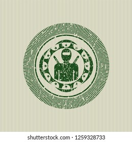 Green ninja icon inside distress rubber seal with grunge texture