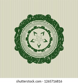 Green ninja star icon inside distressed rubber grunge texture seal