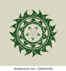 Green ninja star icon inside distressed rubber grunge texture seal