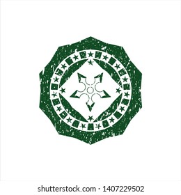 Green ninja star icon inside distressed grunge style stamp
