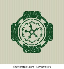 Green ninja star icon inside rubber stamp with grunge texture