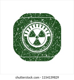 Green nuclear, radioactive icon inside rubber stamp