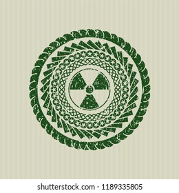 Green nuclear, radioactive icon inside distressed rubber stamp