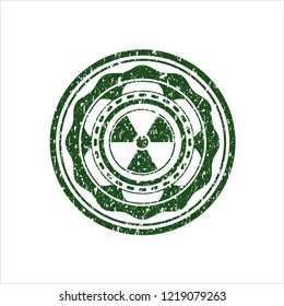 Green nuclear, radioactive icon inside rubber seal with grunge texture