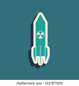 Green Nuclear rocket icon isolated on blue background. Rocket bomb flies down. Long shadow style. Vector Illustration